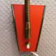 Danish red lacquered wall light with brass details. Estimated 1980s
