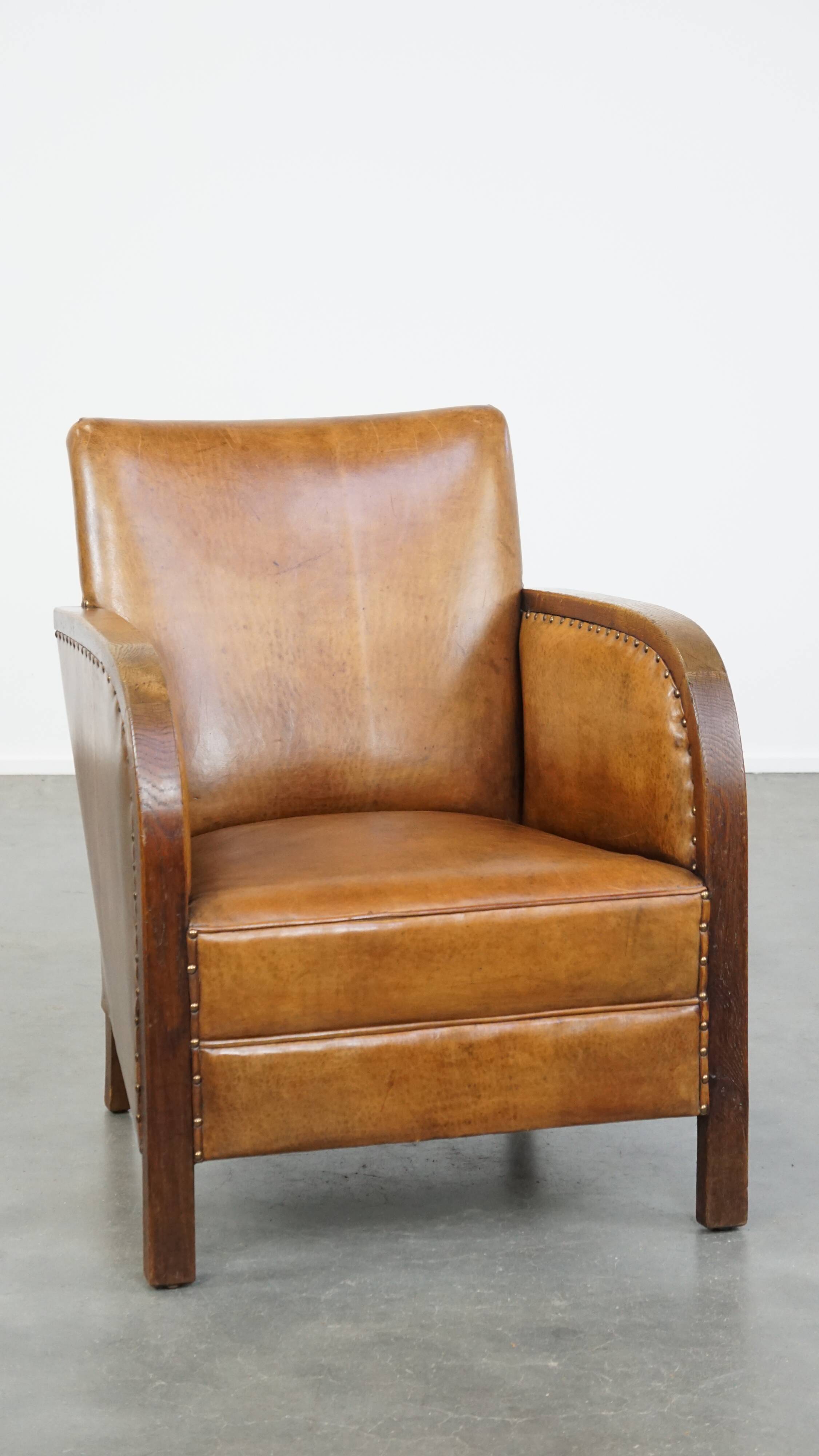 Cognac-colored sheepskin and wooden Art Deco design armchair