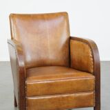 Cognac-colored sheepskin and wooden Art Deco design armchair