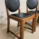 Set of four vintage wooden dining chairs with black leather upholstery, 85 × 45 × 45 cm