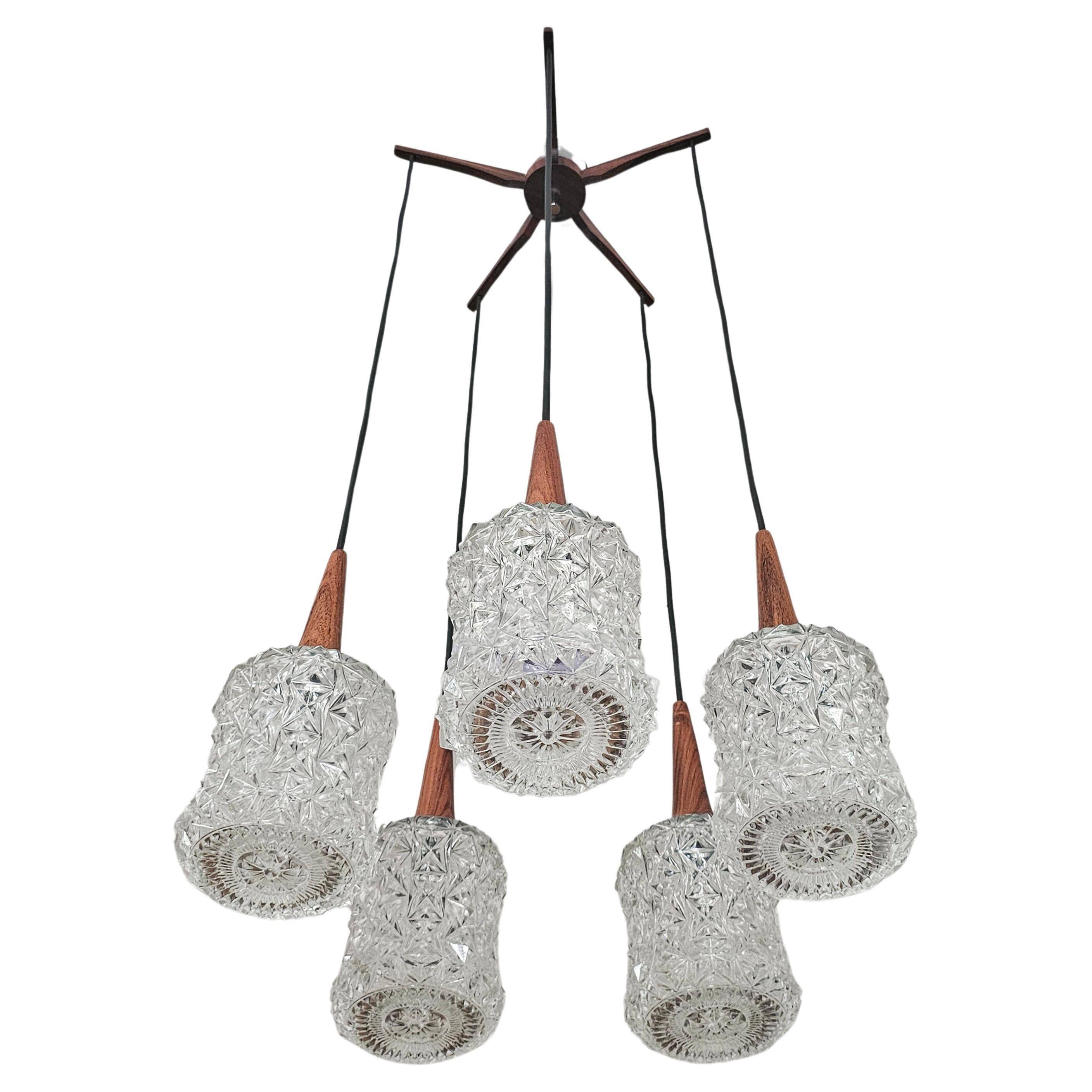 Mid Century Modern spider chandelier in teak, rosewood, and crystal.