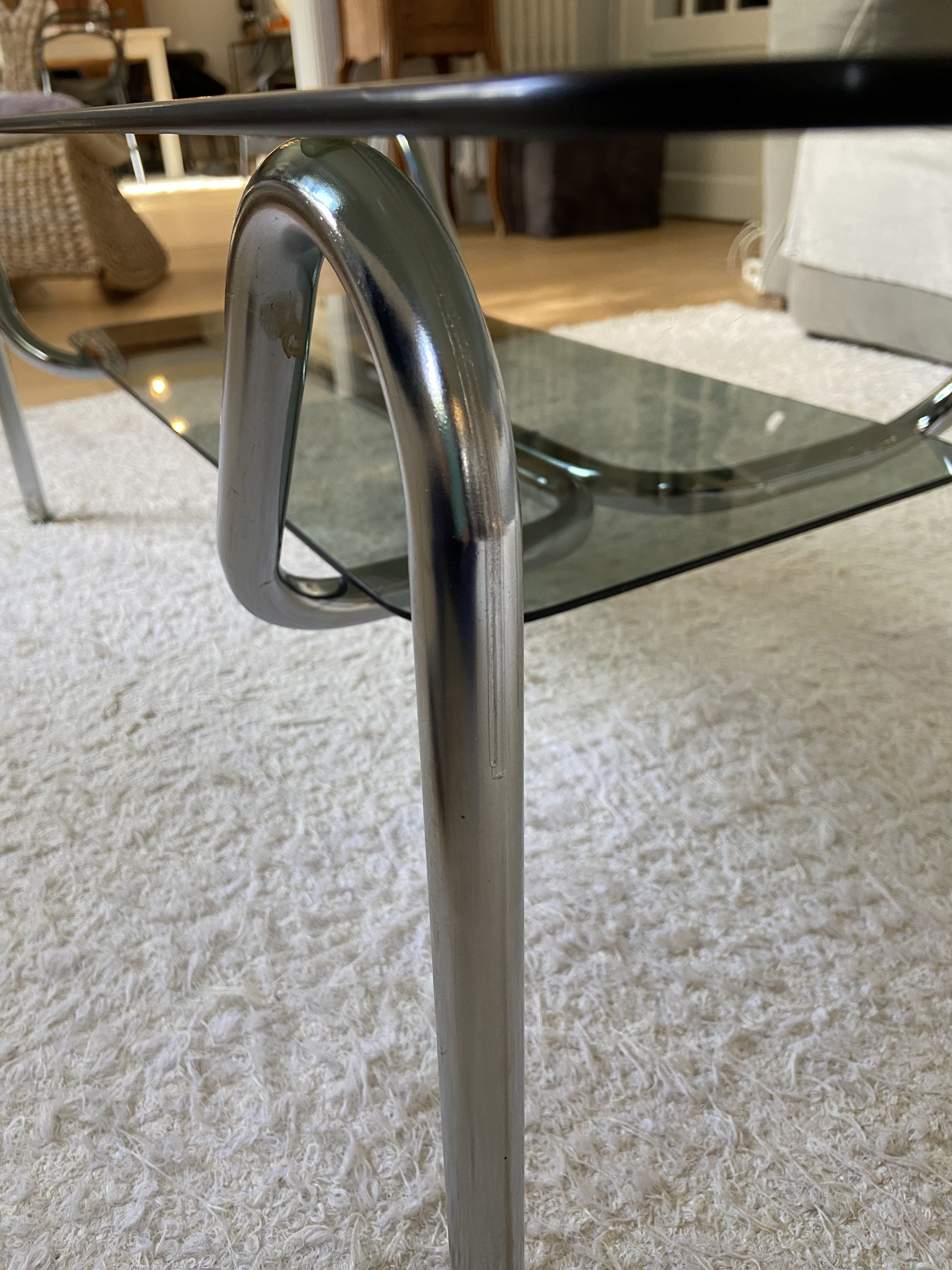Double top coffee table in smoked glass and tubular structure in chromed steel