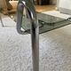 Double top coffee table in smoked glass and tubular structure in chromed steel