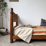 Brutalist style bed with chain and straw
