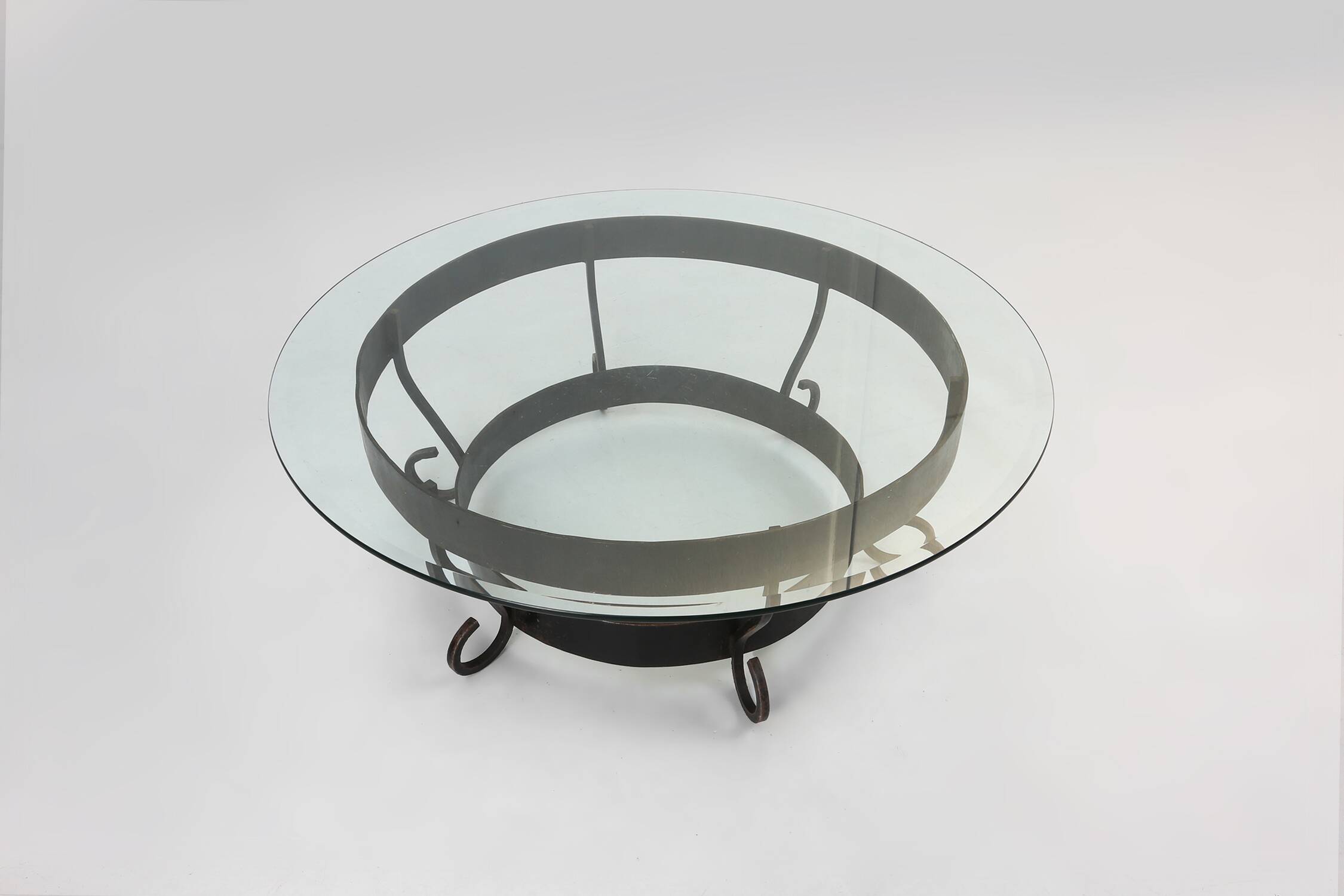 Rustic round coffee table with wrought iron base and glass top, France, 1930s
