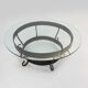Rustic round coffee table with wrought iron base and glass top, France, 1930s