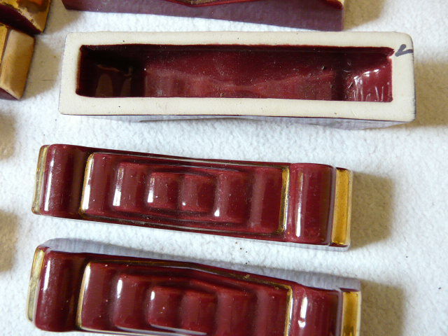 together 12 carries knives and a red enamelled earthenware bottle