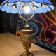 bronze lamp from 1900, solid, inlaid with enamels and glass shade