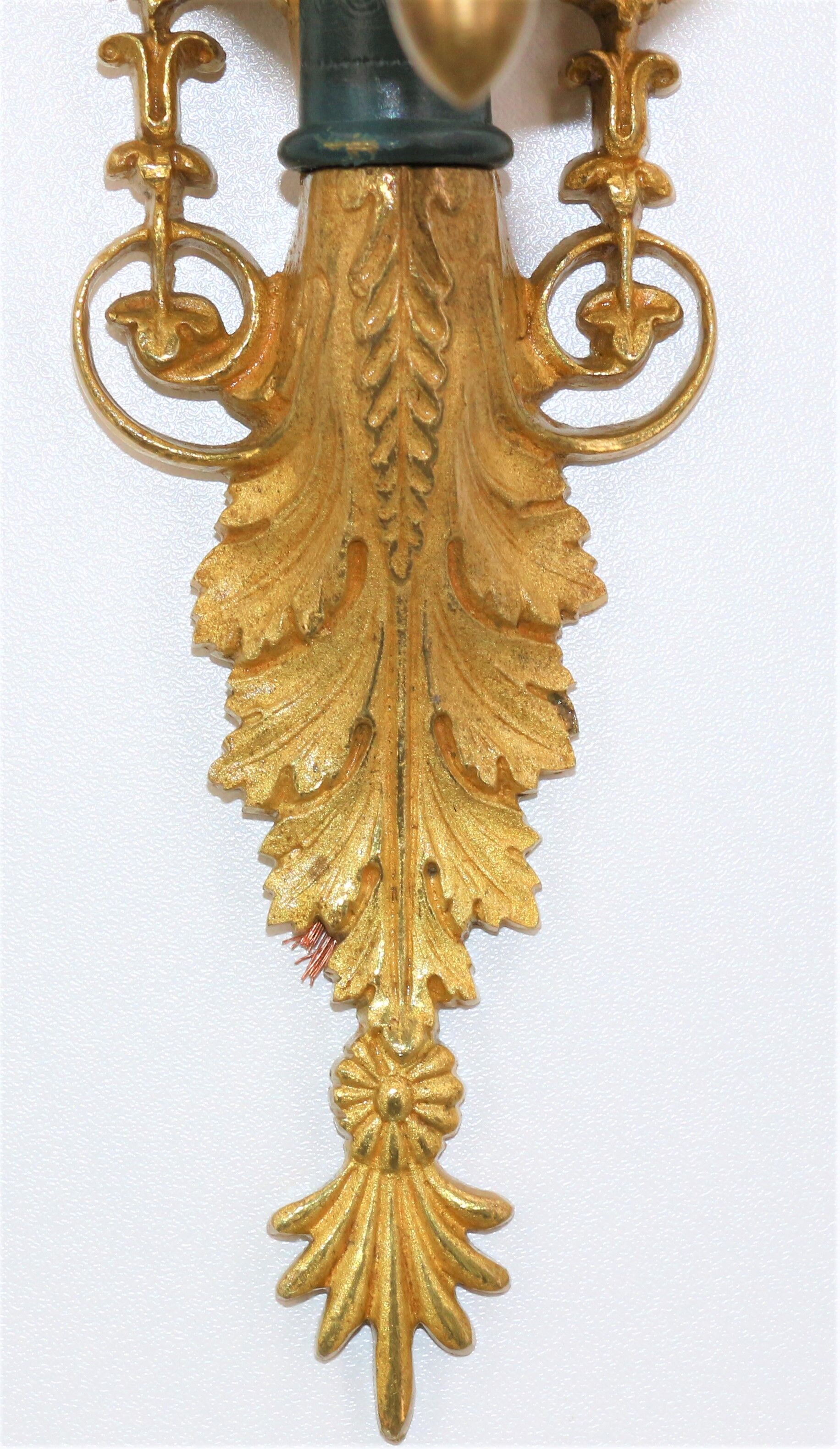 Pair of golden bronze wall lamps in triumphant empire swan style