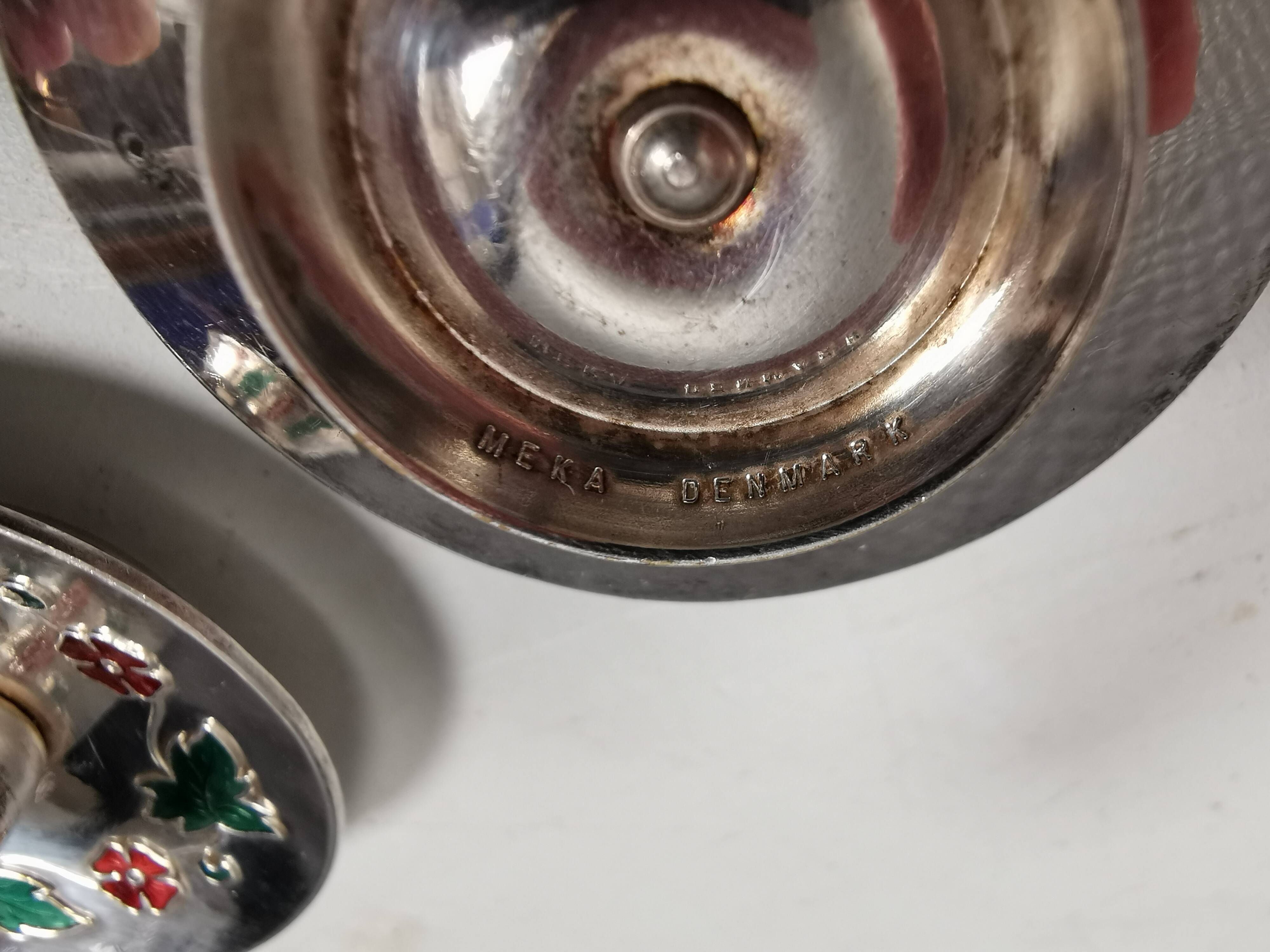 Silver-plated candle holders with inlaid red and green enamel