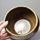 Vintage glazed stoneware bowl or planter in rustic wabi-sabi style.