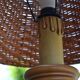 Large wooden lamp with a woven rattan shade.