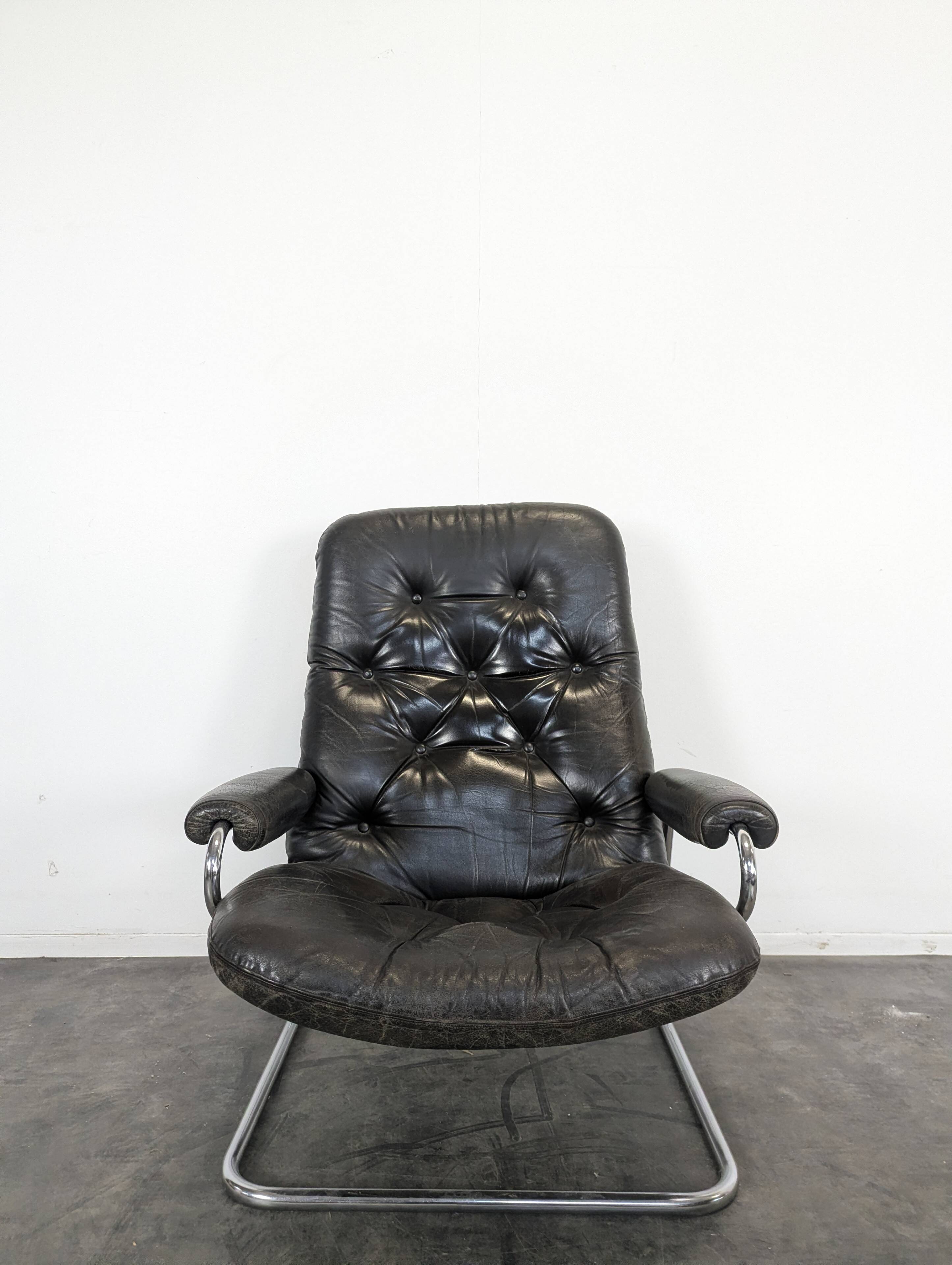 Stressless armchair and ottoman in leather from the 1970s.