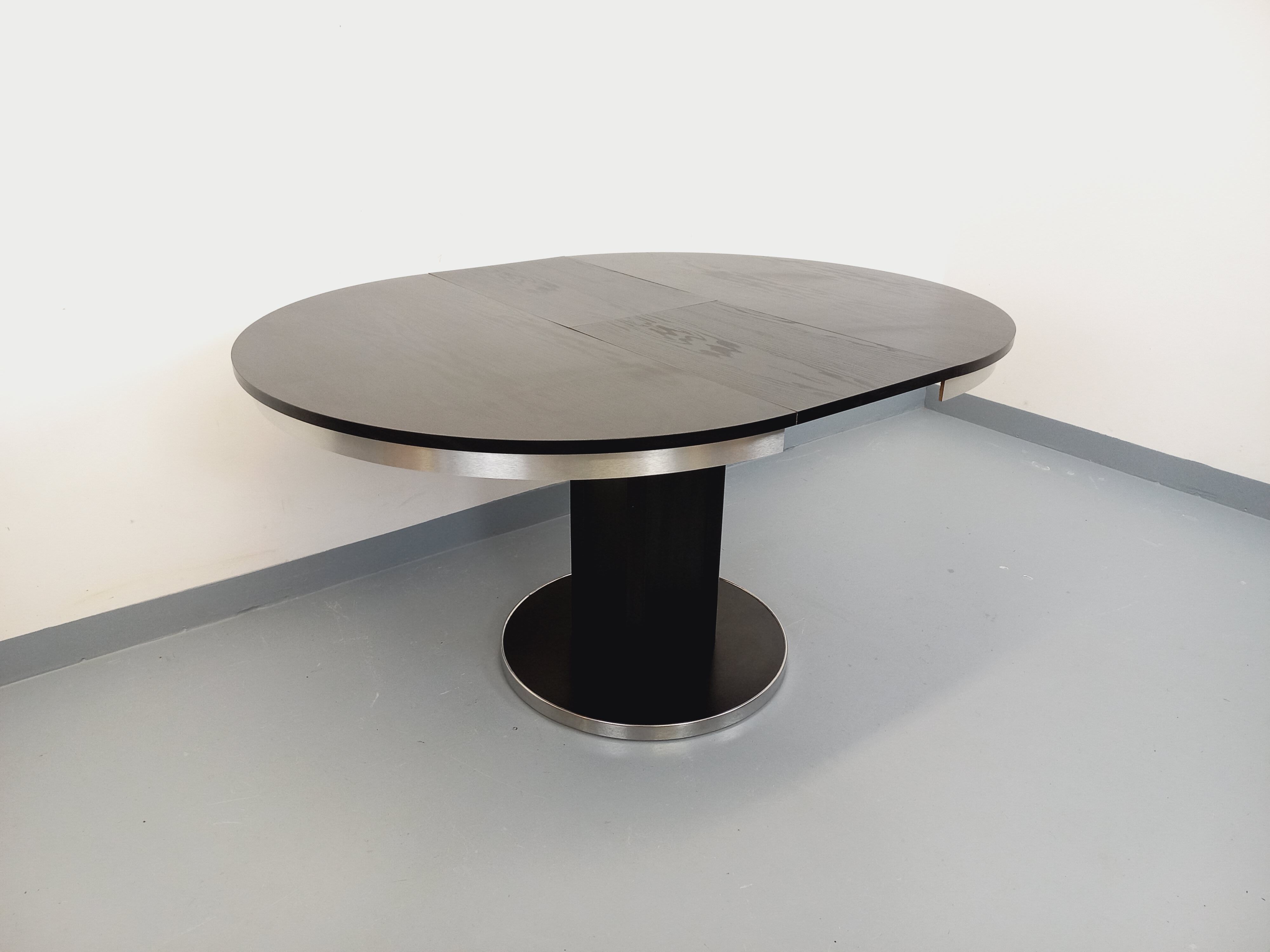 Vintage dining table in melamine with a black wood effect and chrome metal.
