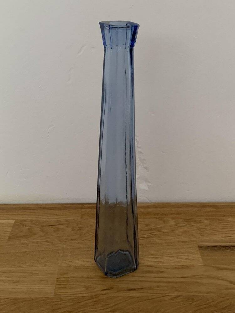 Translucent blue glass vase from the 1980s — tall prismatic silhouette, polygonal base.