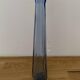 Translucent blue glass vase from the 1980s — tall prismatic silhouette, polygonal base.