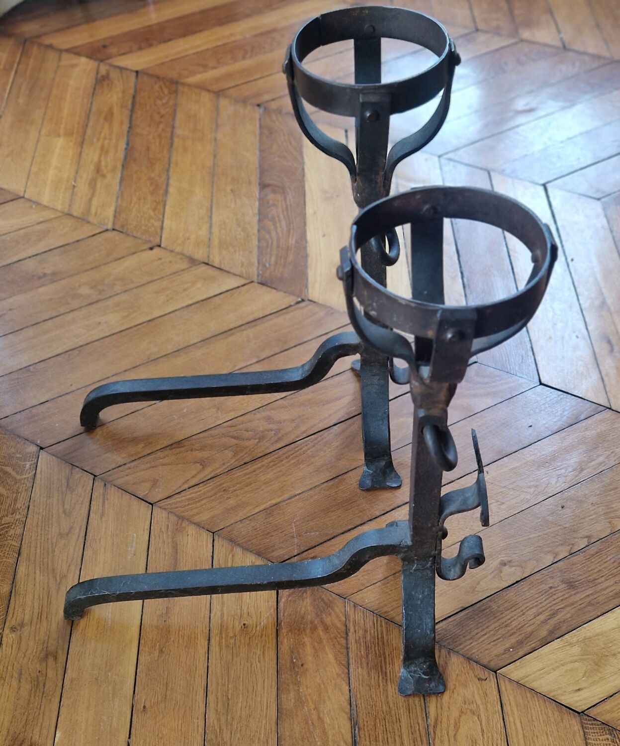 Pair of wrought iron andirons by Landier from the 17th century.