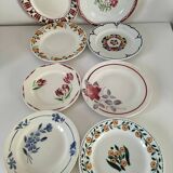 Set of 8 ironstone plates with coordinated designs.