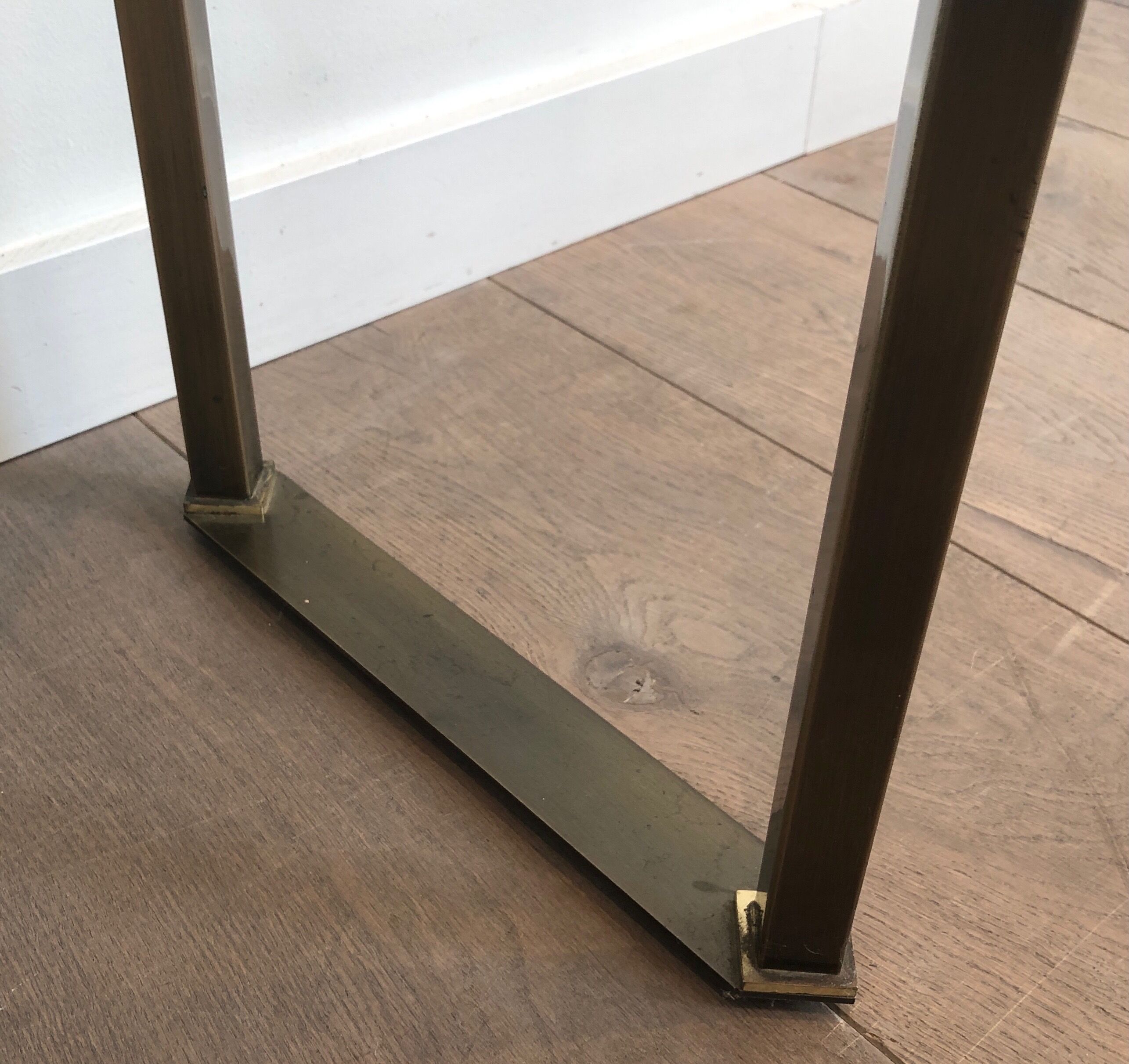 Console in brushed steel and brass and tray formed of a glass slab. French work. Around 1970