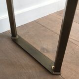 Console en acier brossé et laiton et plateau formé d'une dalle de verre. Travail français. Vers 1970