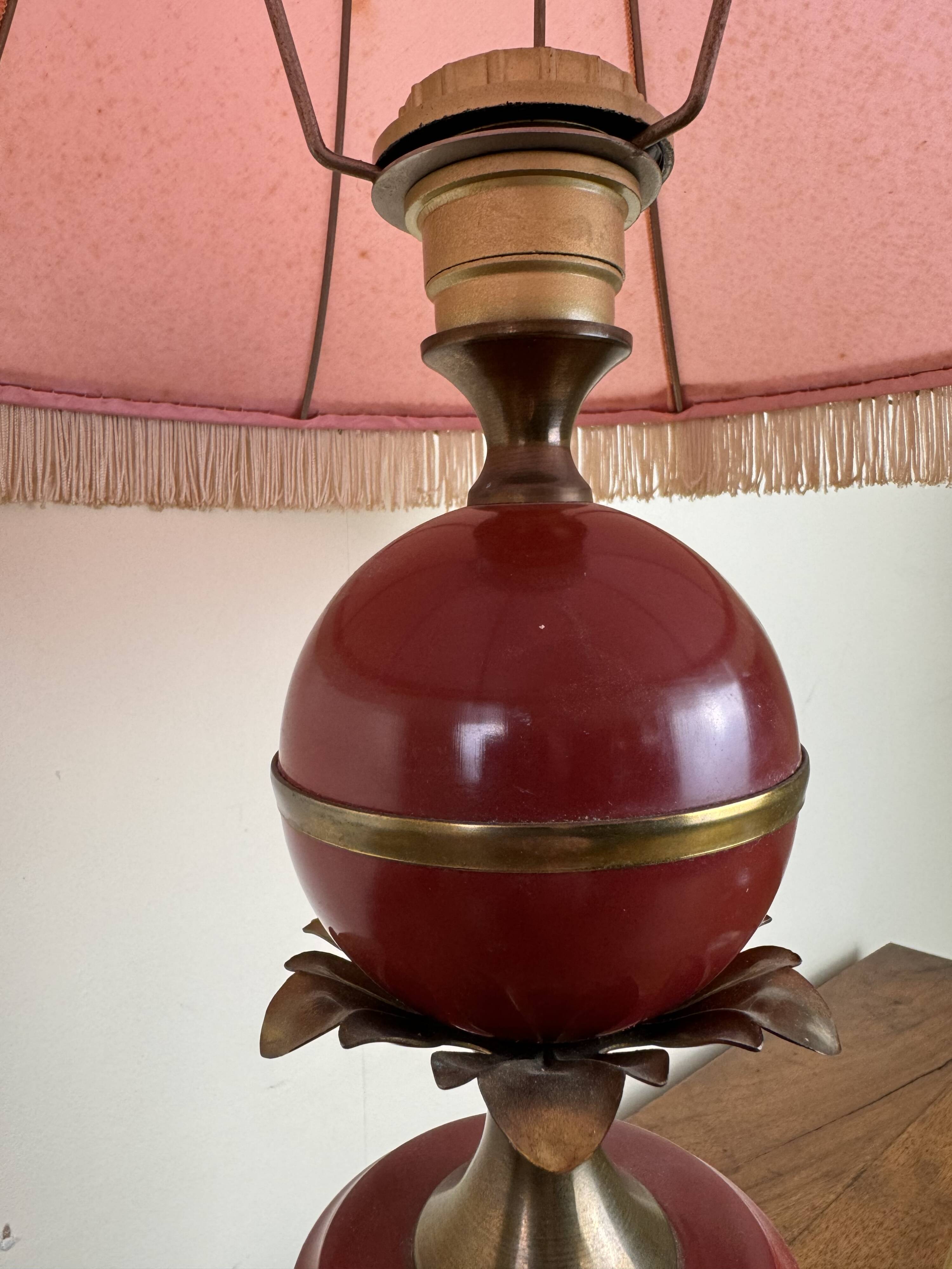 Art deco style desk lamp with a burgundy red sphere in the center the body is in lacquered iron