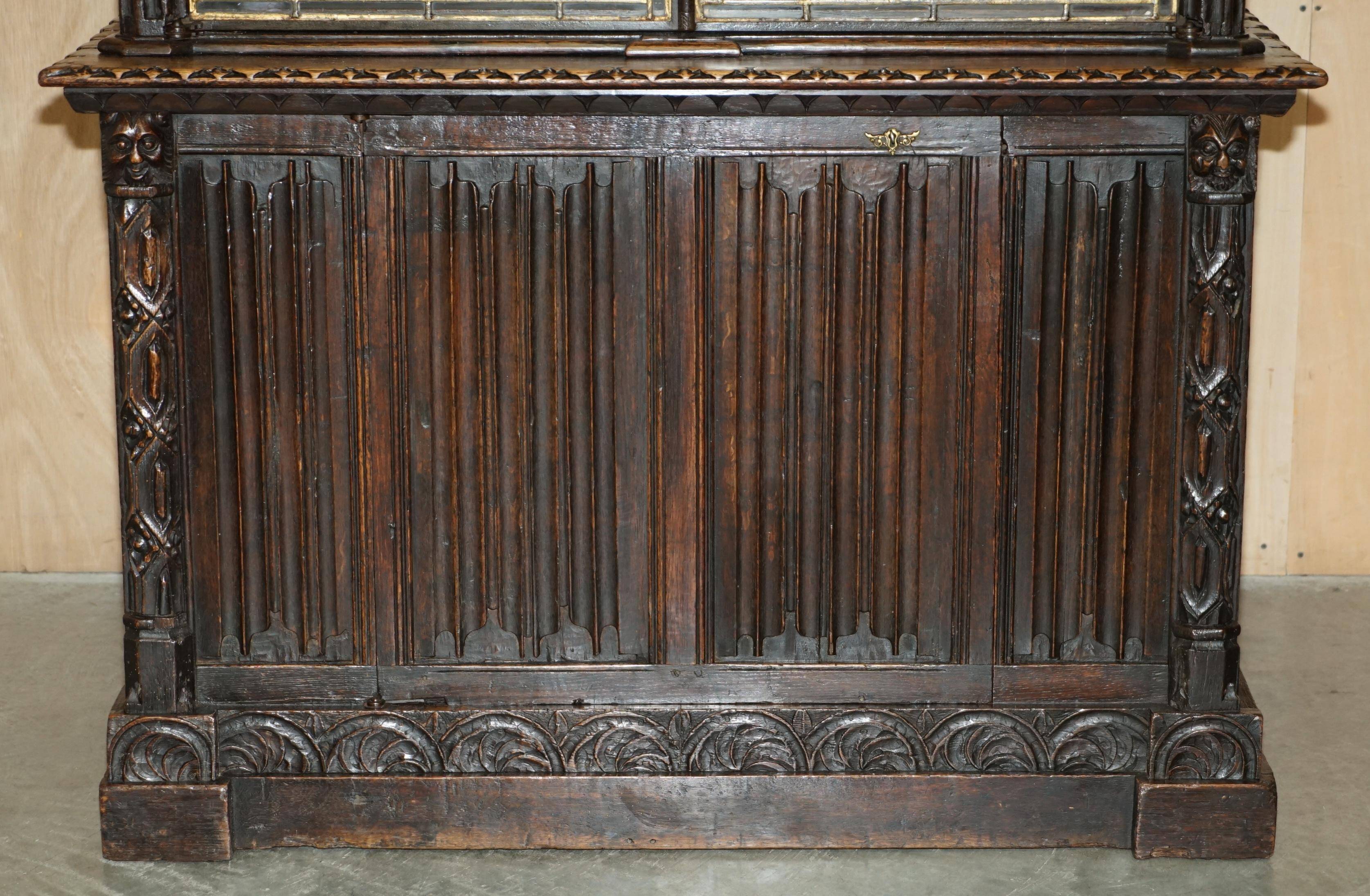 Jacobean hardwood library with carved panels and glass doors.
