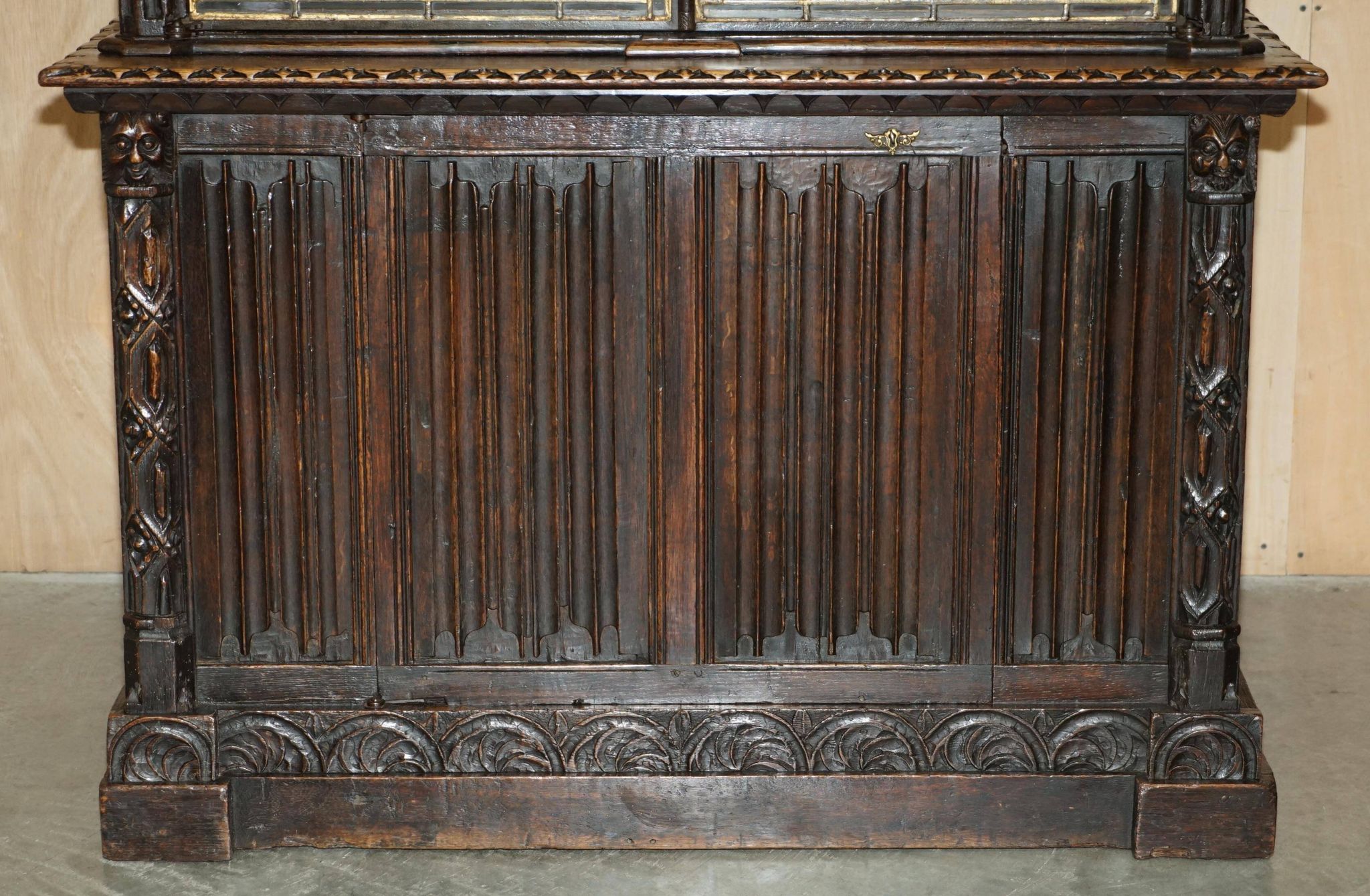 Jacobean hardwood library with carved panels and glass doors.