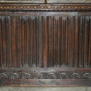 Jacobean hardwood library with carved panels and glass doors.
