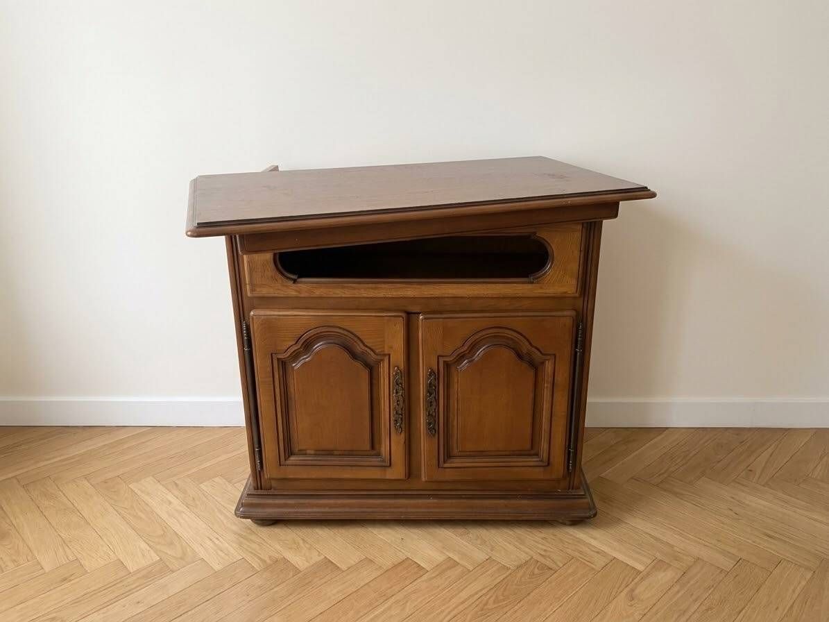 Rustic wooden TV unit with a swivel top and moulded doors.