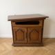 Rustic wooden TV unit with a swivel top and moulded doors.