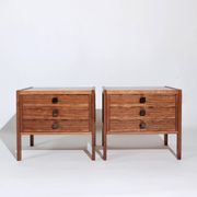 Pair of vintage Scandinavian bedside tables, three drawers, honey-toned wood.