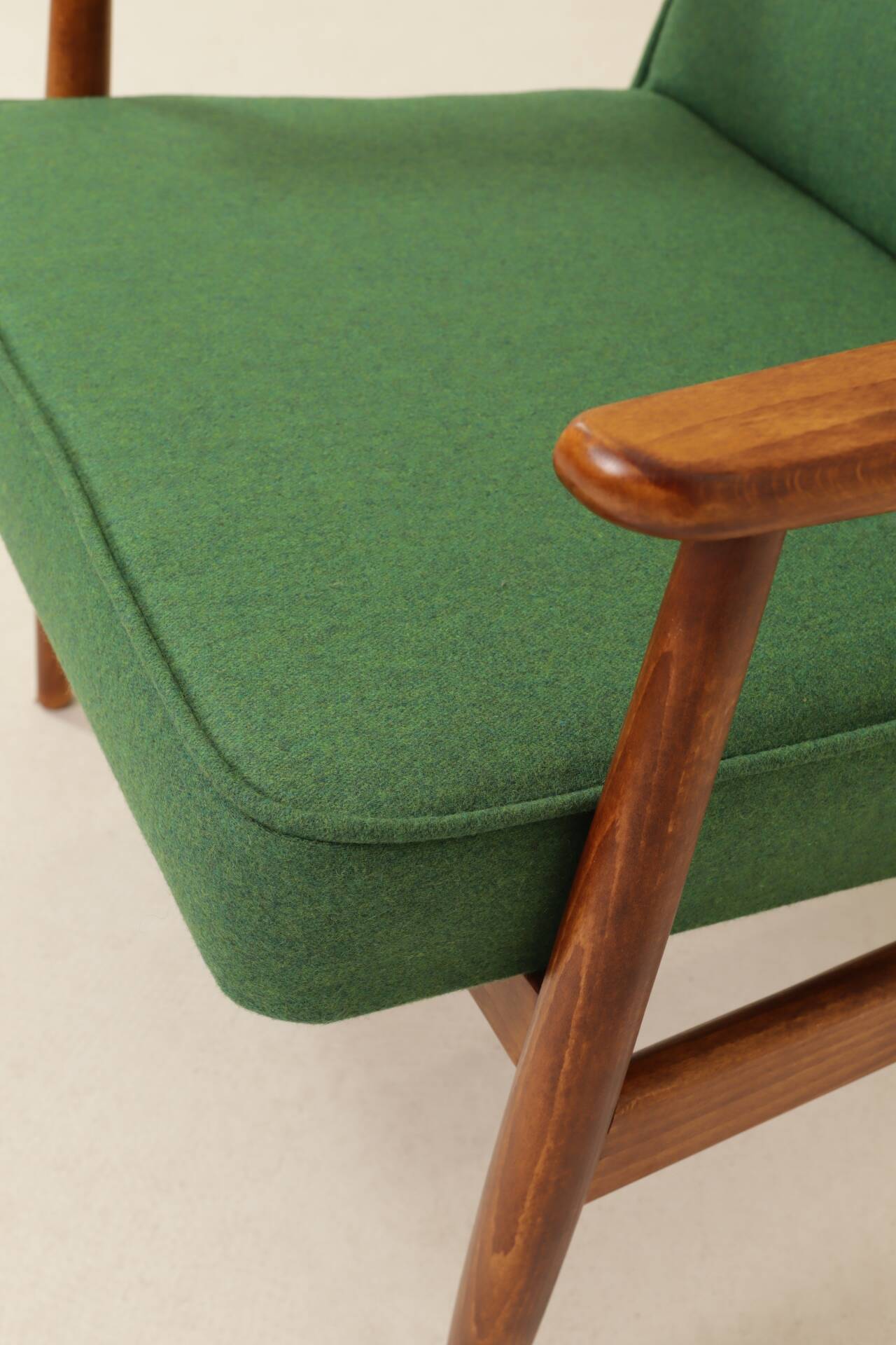 Scandinavian modern chair in green wool, vintage wooden armchair.