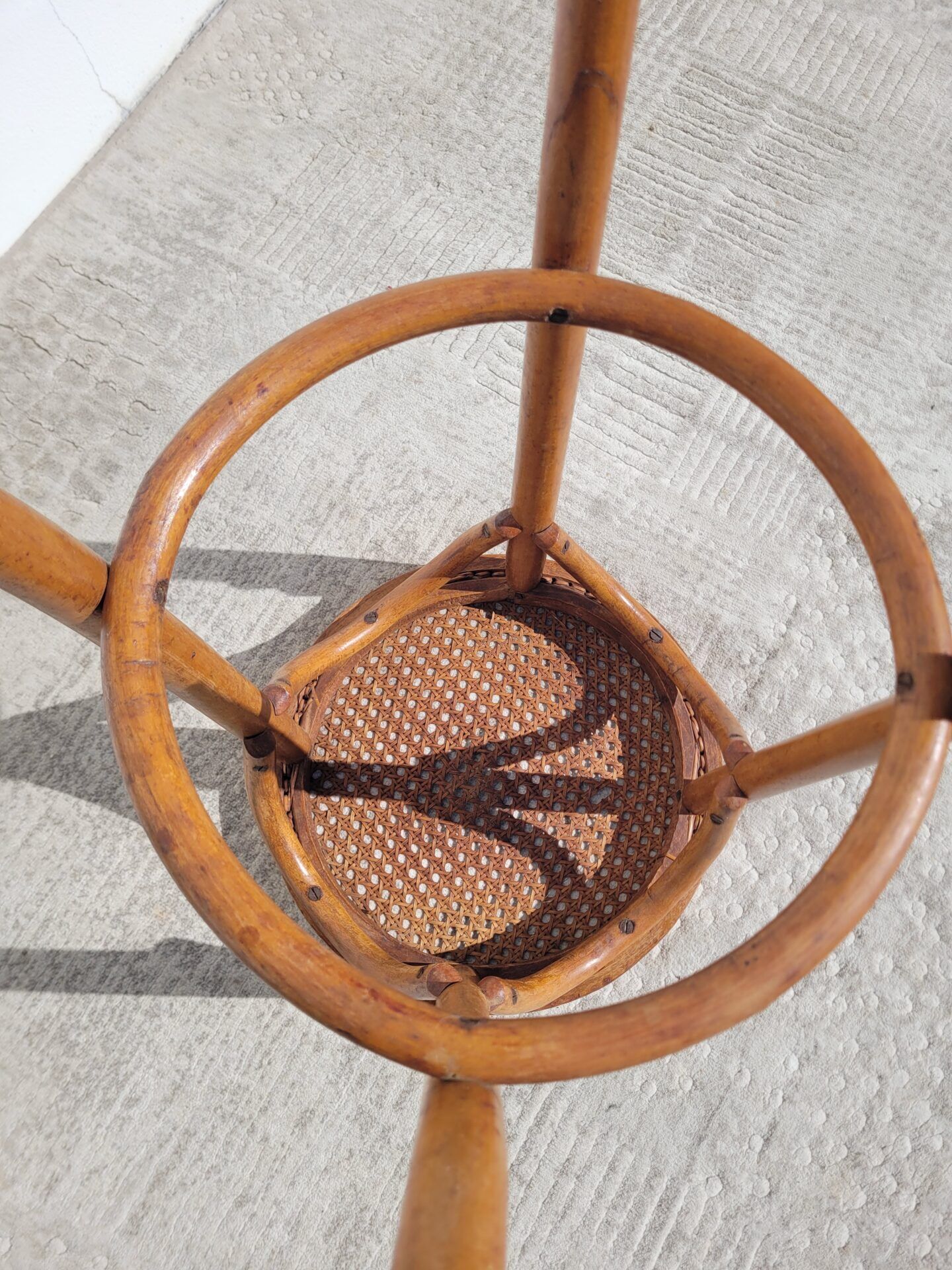 Old low caned bistro stool