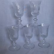 Ancient footed crystal glasses with relief twisted fluted goblets.