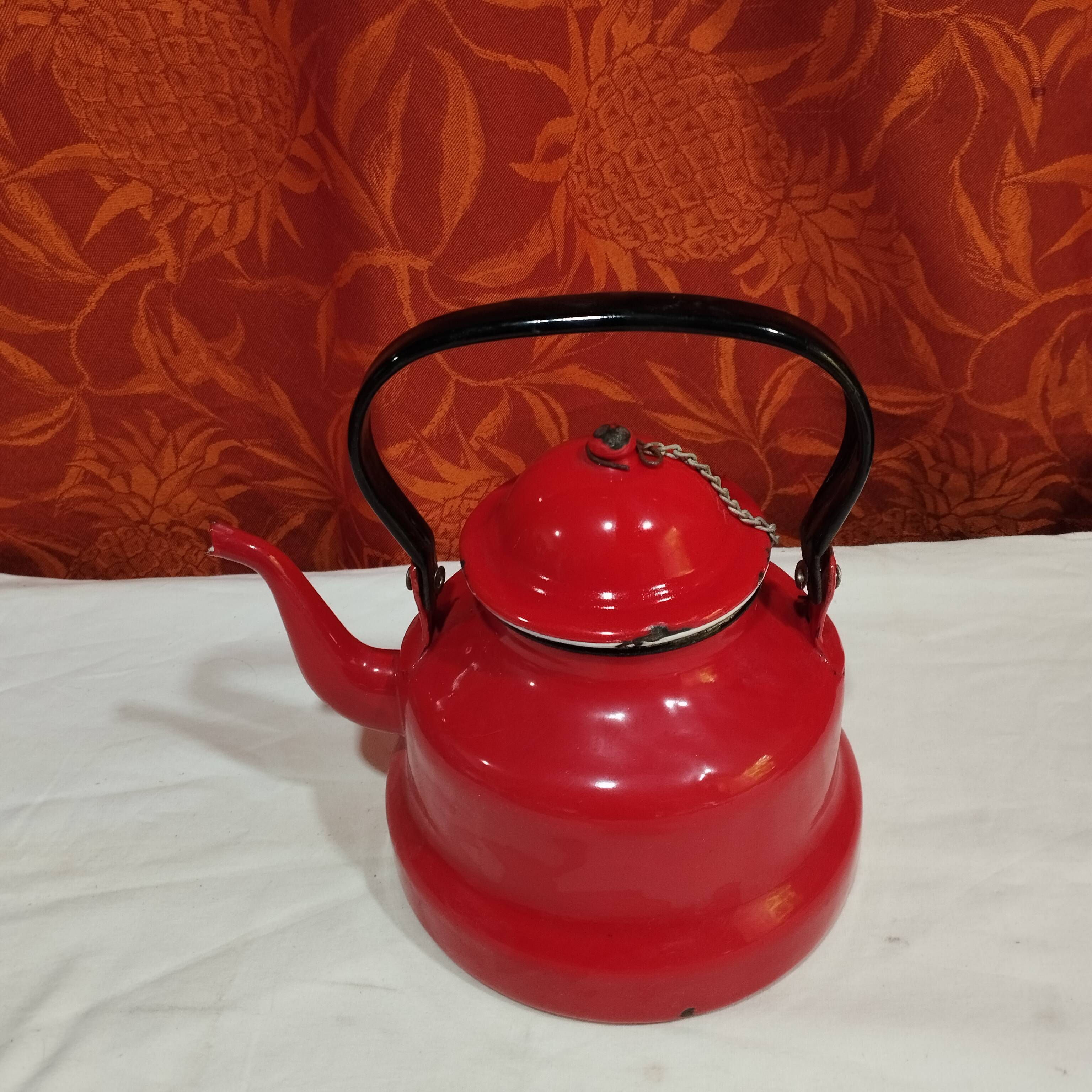 red enamelled sheet metal kettle