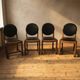 Set of four vintage wooden dining chairs with black leather upholstery