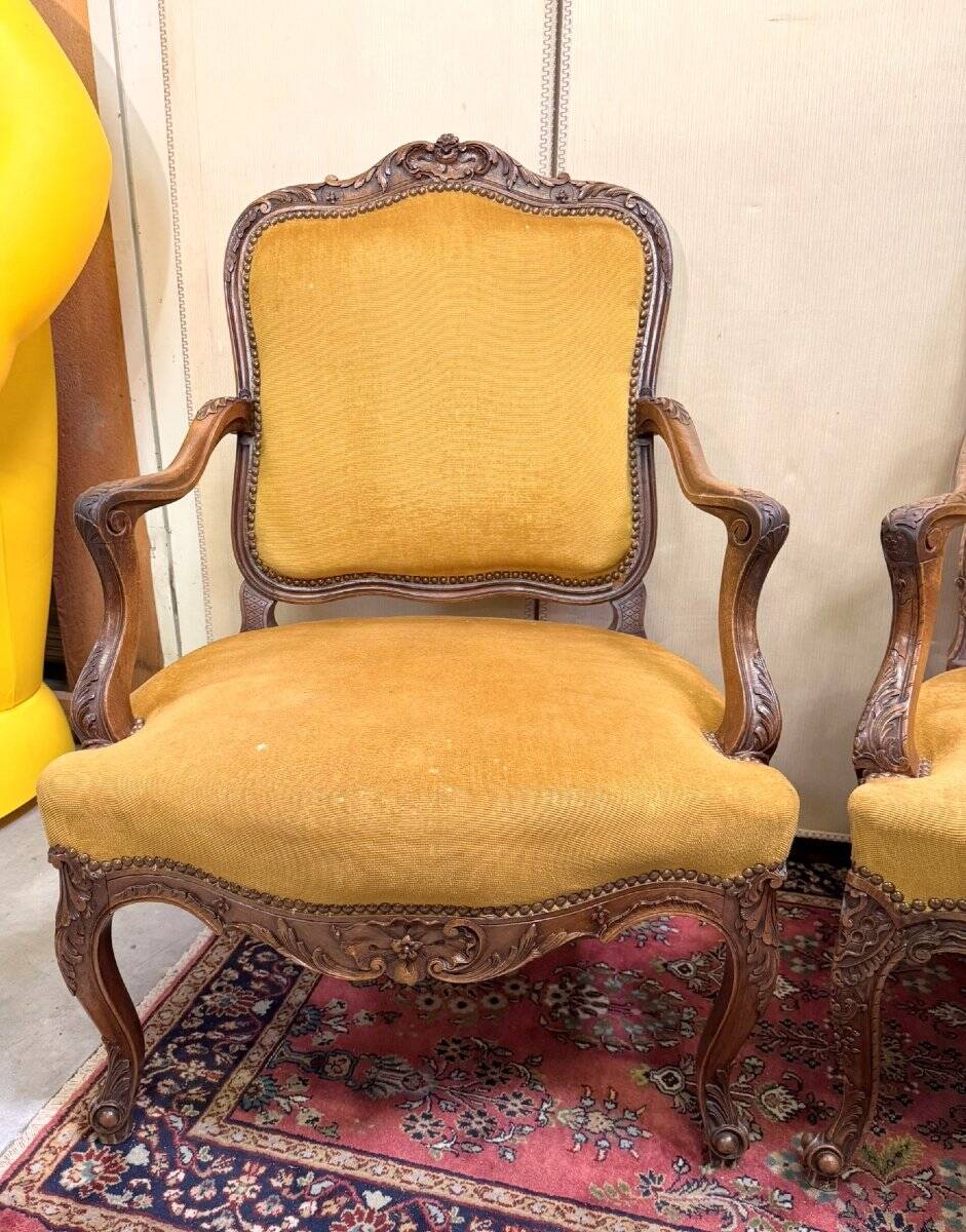 Pair of faux Louis XV armchairs in fully carved walnut