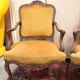 Pair of faux Louis XV armchairs in fully carved walnut