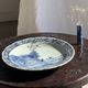 Vintage hollow circular plate in blue and white Boch pottery.