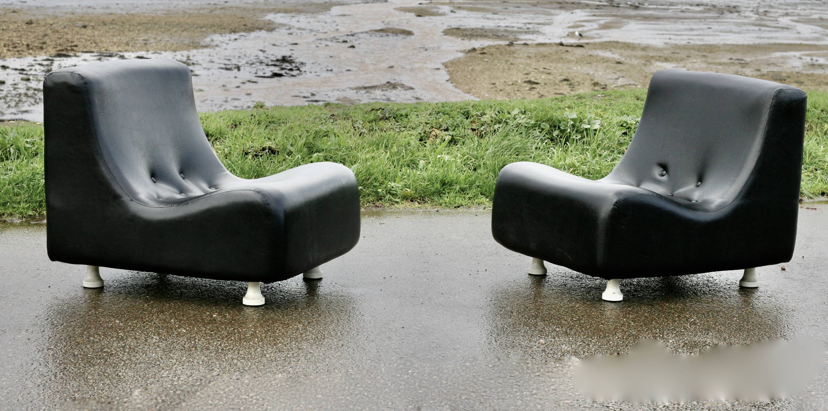 Pair of “space age” low chairs. Black faux leather. Circa 1970