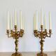Solid bronze candlesticks decorated with putti, acanthus leaves and lion heads
