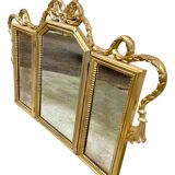Triptych-shaped mirror in gilded wood and carved with a frieze