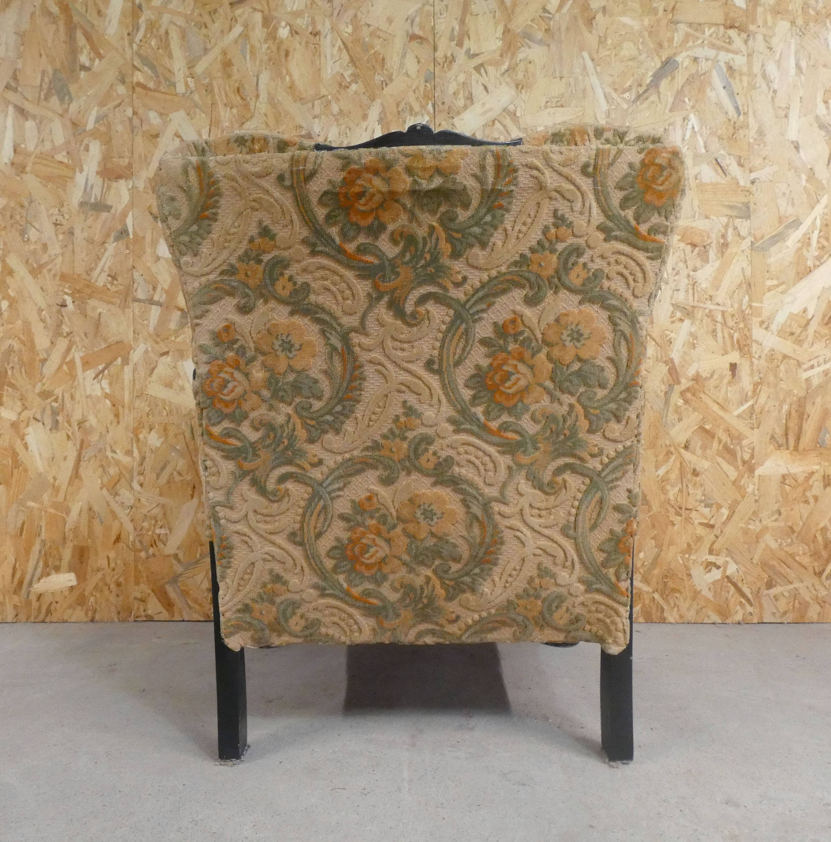 Old armchair upholstered in velvet, carved and caned wood