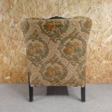 Old armchair upholstered in velvet, carved and caned wood
