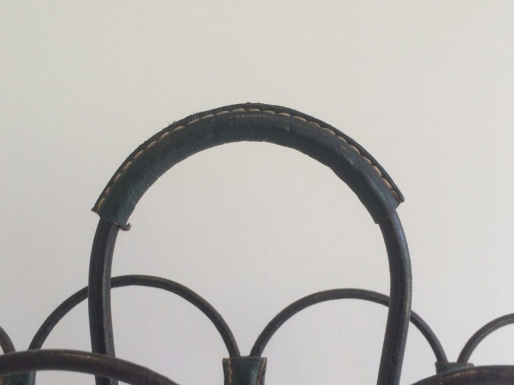 Magazine rack in leather and black lacquered metal. Attributed to Jacques Adnet