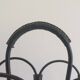 Magazine rack in leather and black lacquered metal. Attributed to Jacques Adnet