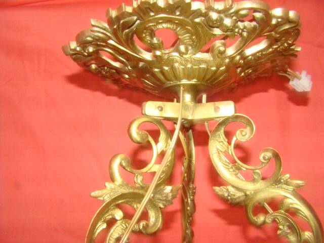 circular chandelier with a brass frame equipped with crystal drops