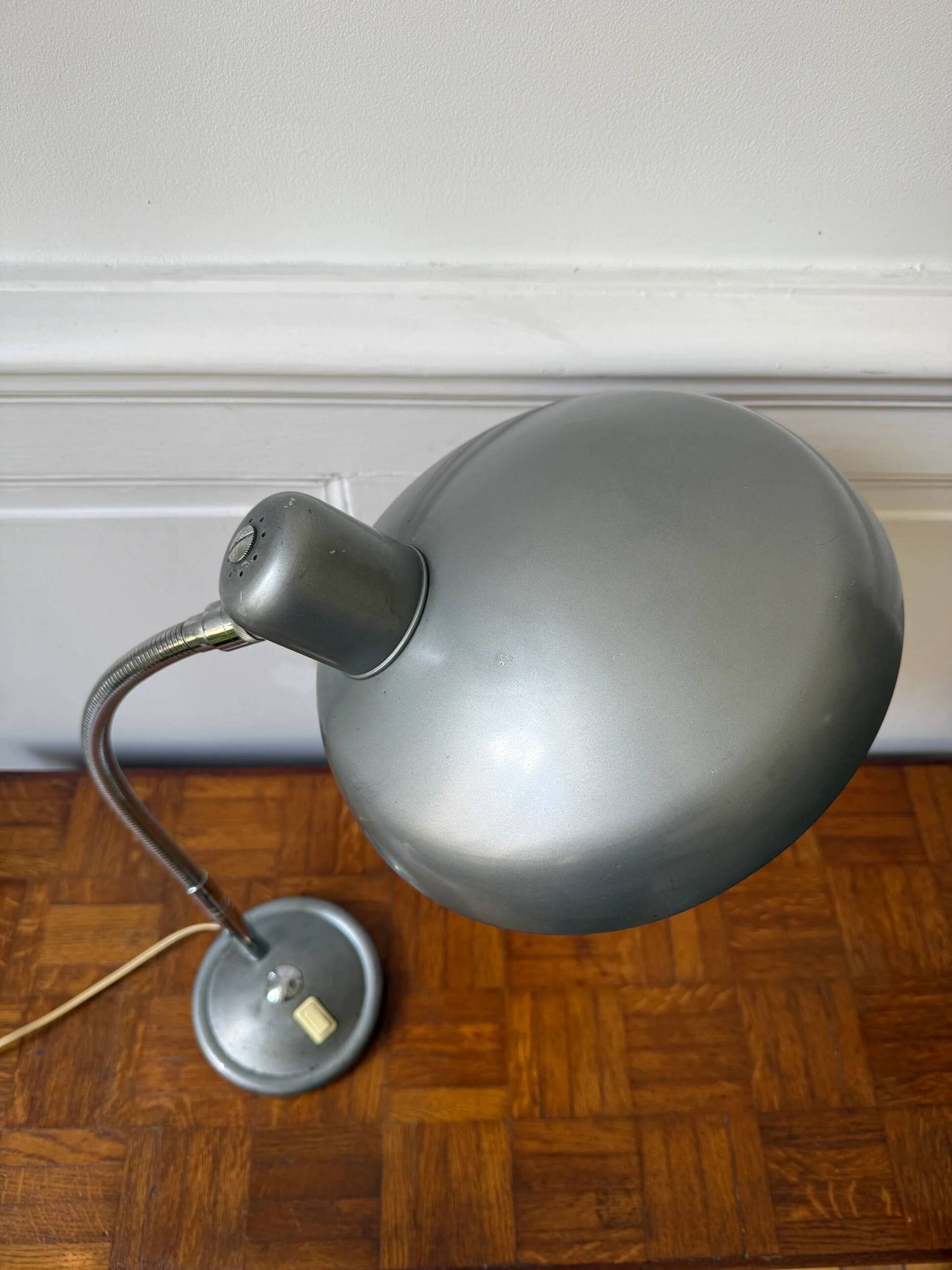Industrial metal workshop lamp with a gooseneck.