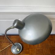 Industrial metal workshop lamp with a gooseneck.
