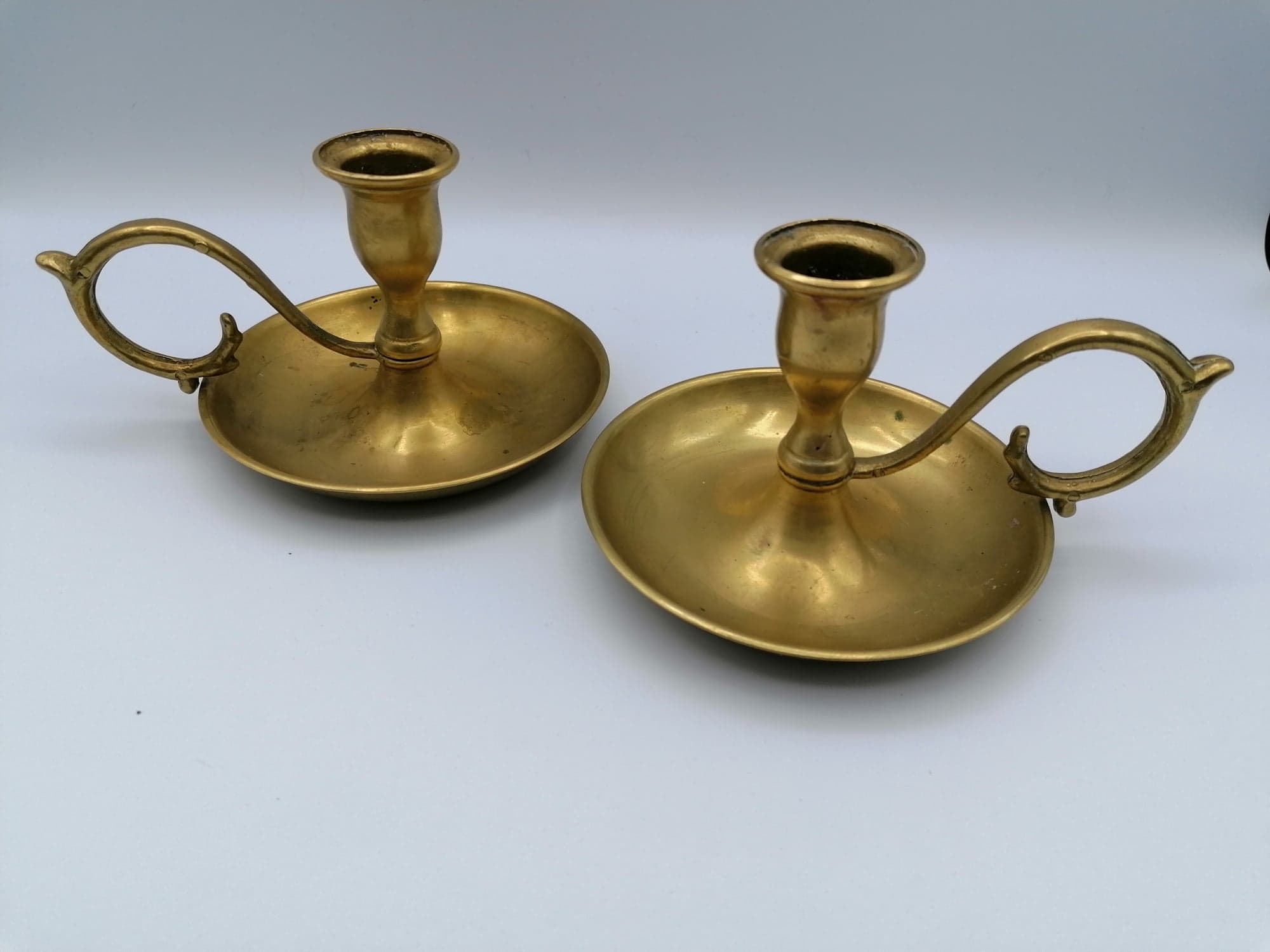 Pair of brass hand candlesticks